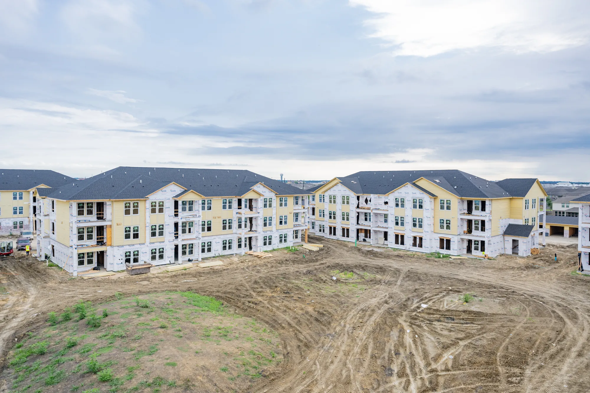 Window installation at The Brickyard at Barbers Hill — exterior envelope and wood framing by Epic Contractors
