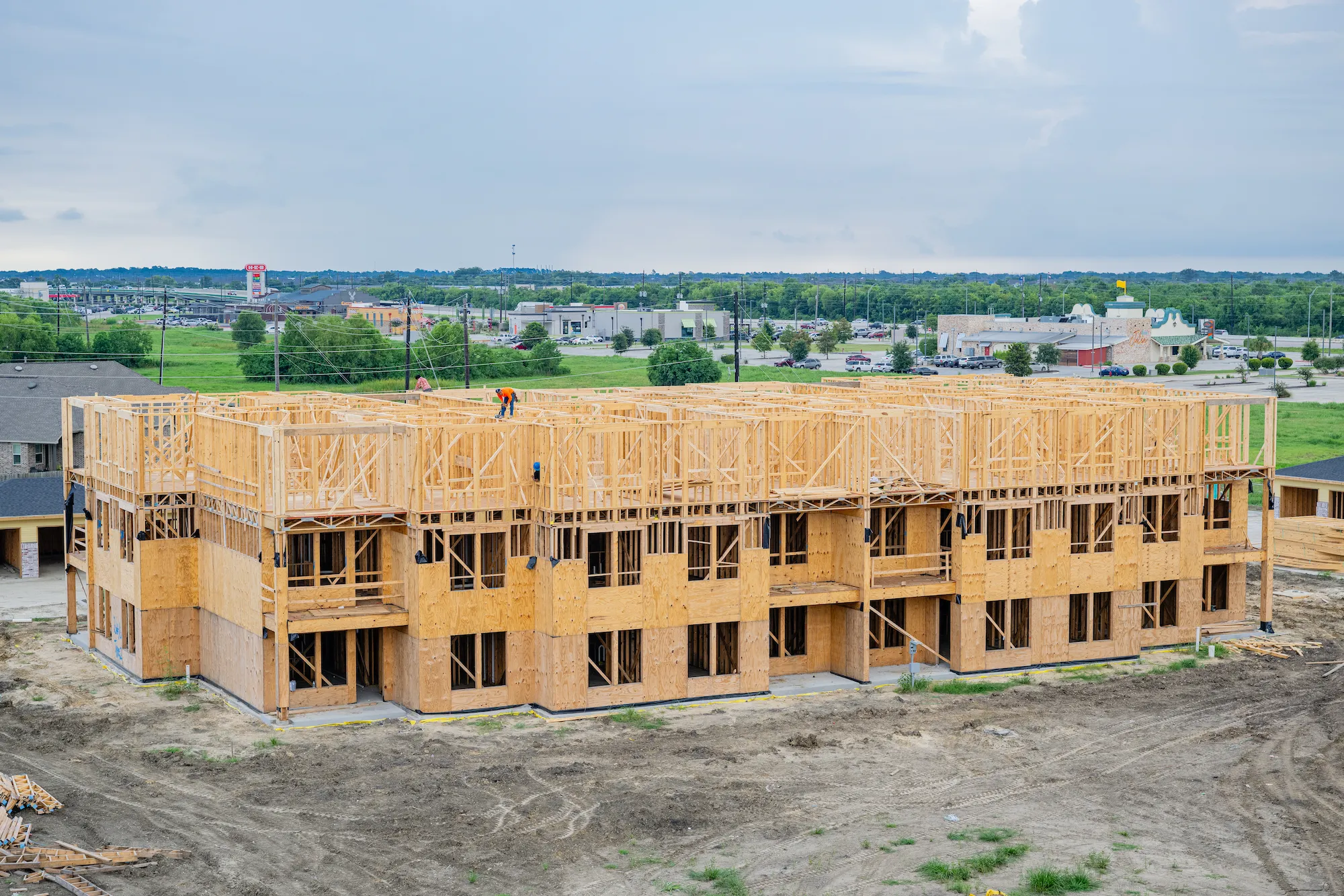 Building exterior under construction at The Brickyard at Barbers Hill — wood framing and exterior envelope by Epic Contractors