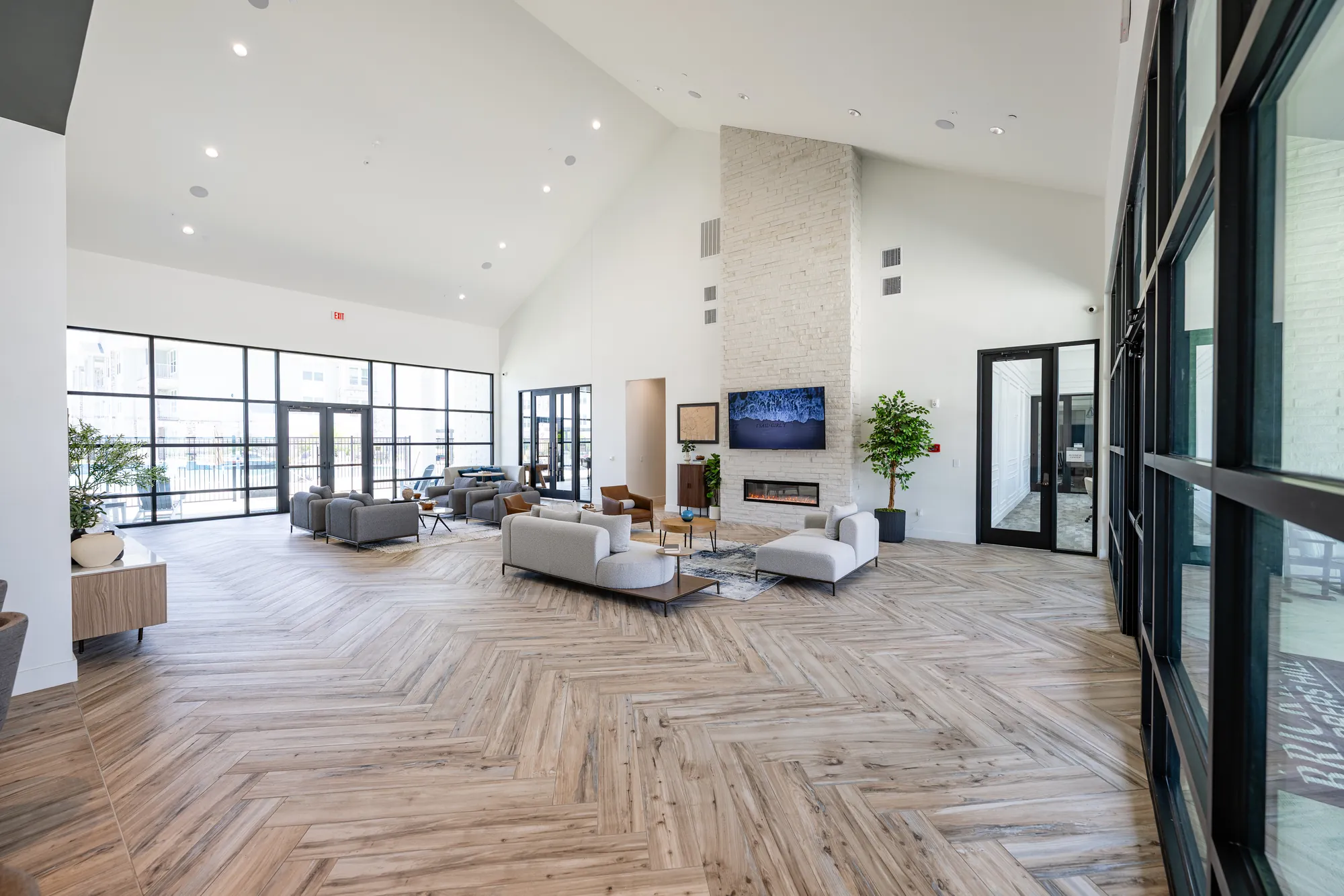 Clubhouse great room at The Brickyard at Barbers Hill — framed vaulted ceiling, fireplace, and door openings by Epic Contractors