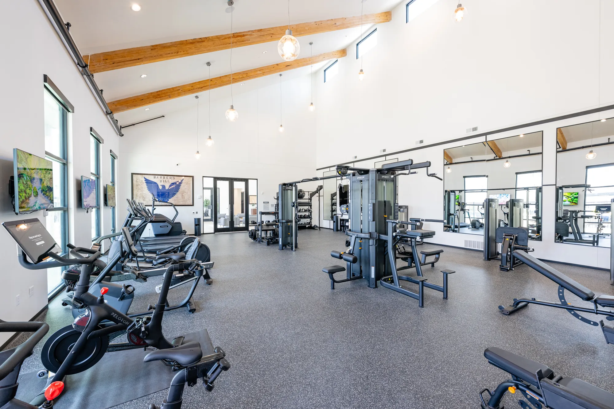 Fitness center at The Brickyard at Barbers Hill — framed vaulted ceiling with exposed beams by Epic Contractors