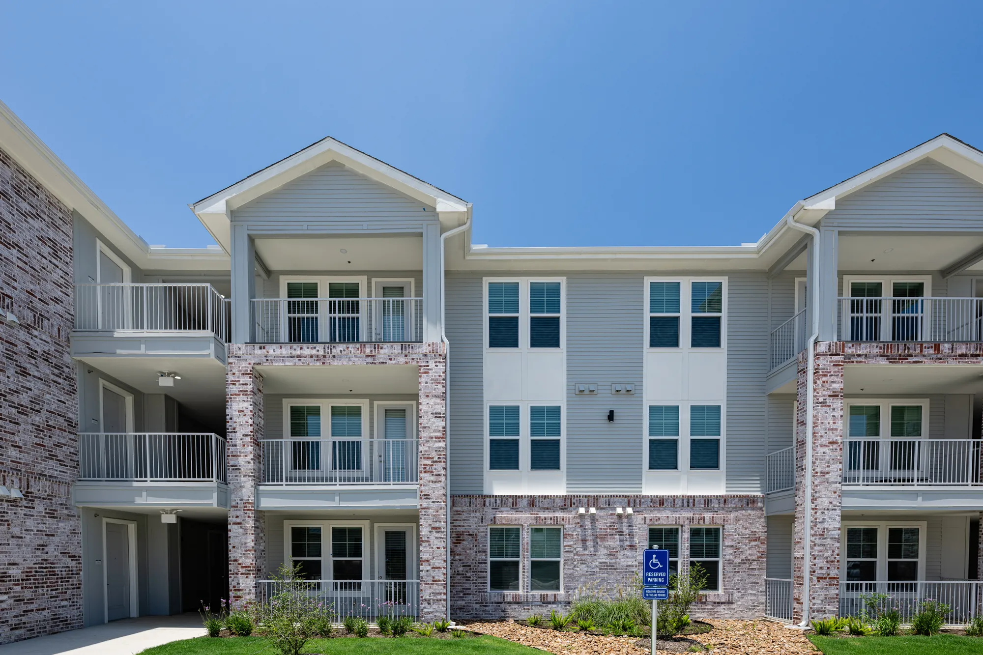 Completed residential buildings at The Brickyard at Barbers Hill — wood framing, sheathing, and exterior envelope by Epic Contractors