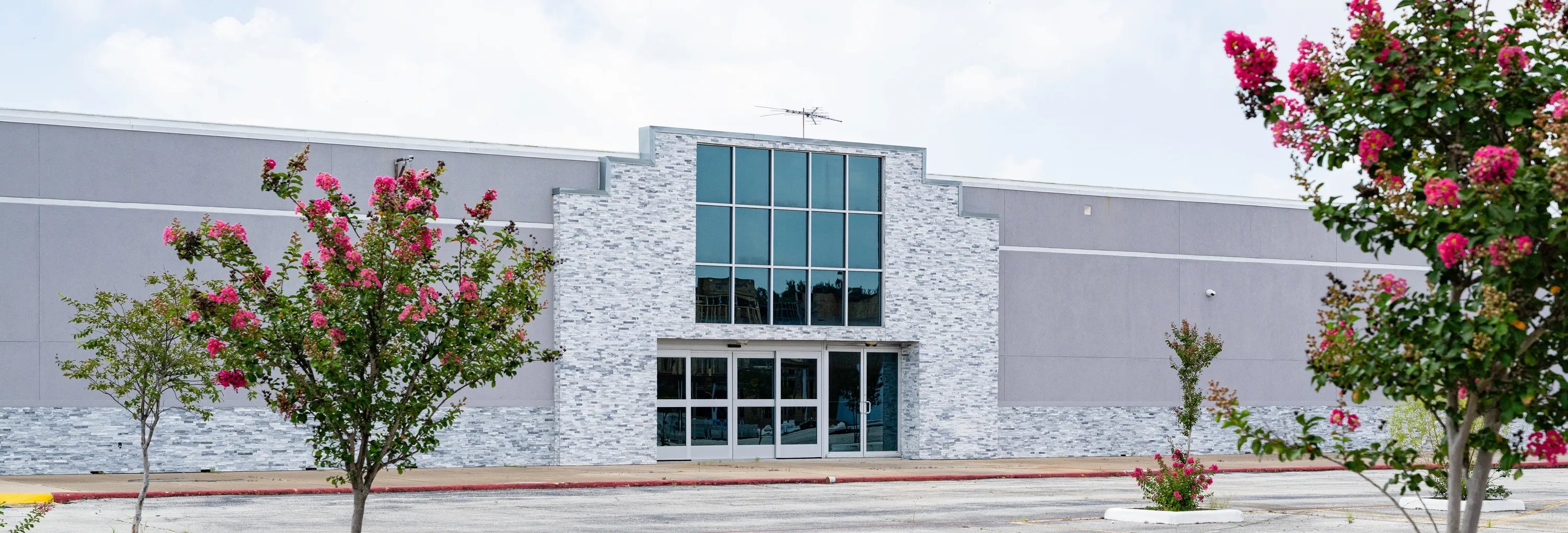 Front elevation and entry signage at the Mountain of Fire Convention Center, Houston — big-box retail converted to assembly use, delivered by Epic Contractors as general contractor