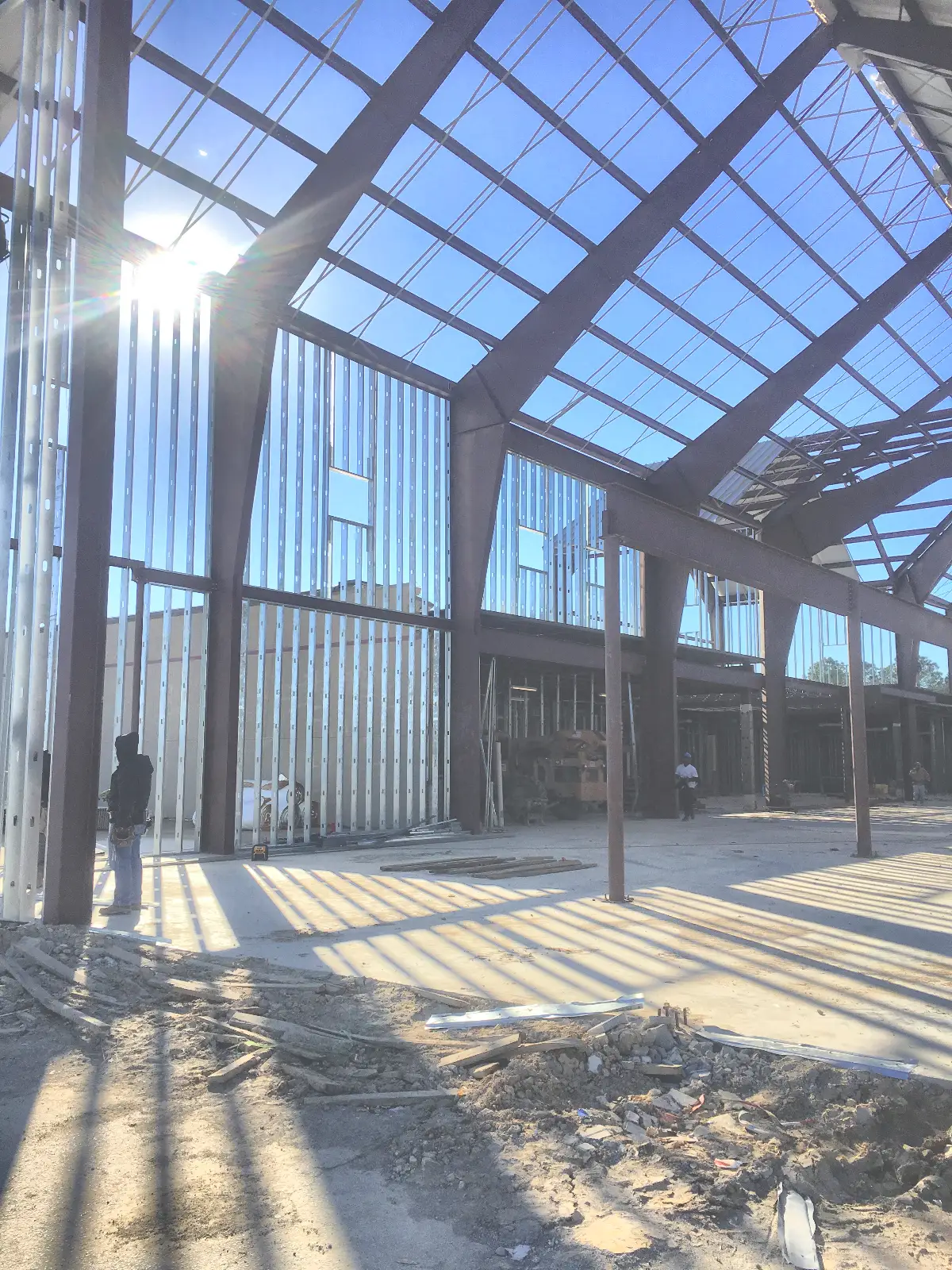 Two-story structural shell of the former Kmart mid-conversion, metal stud framing underway — Mountain of Fire Ministries, Houston