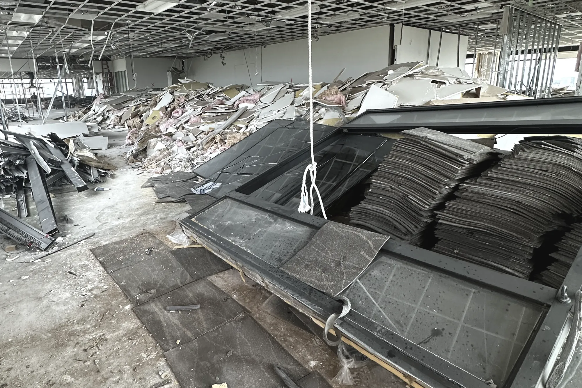 The Watt at Westlake — interior demolition in progress, ceiling grid stripped, partitions and finishes removed, raised floor panels stacked