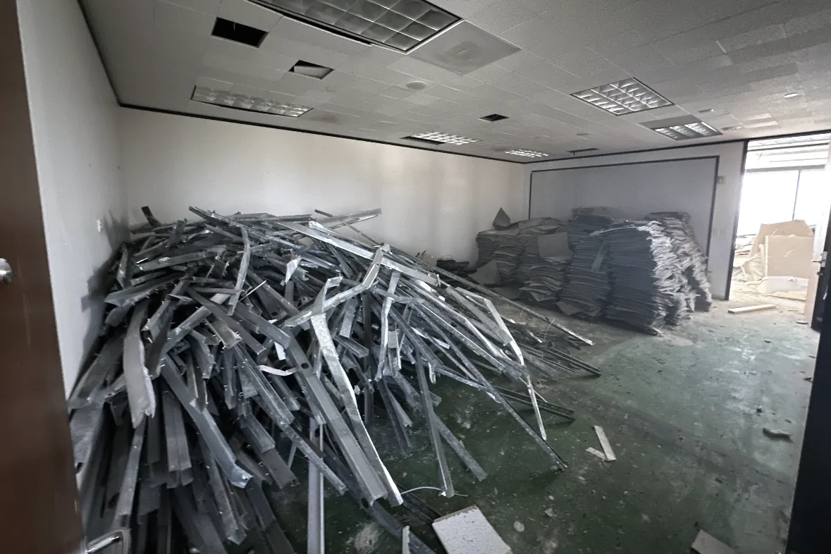 The Watt at Westlake — demolished metal stud partitions stacked in an office suite during interior removal